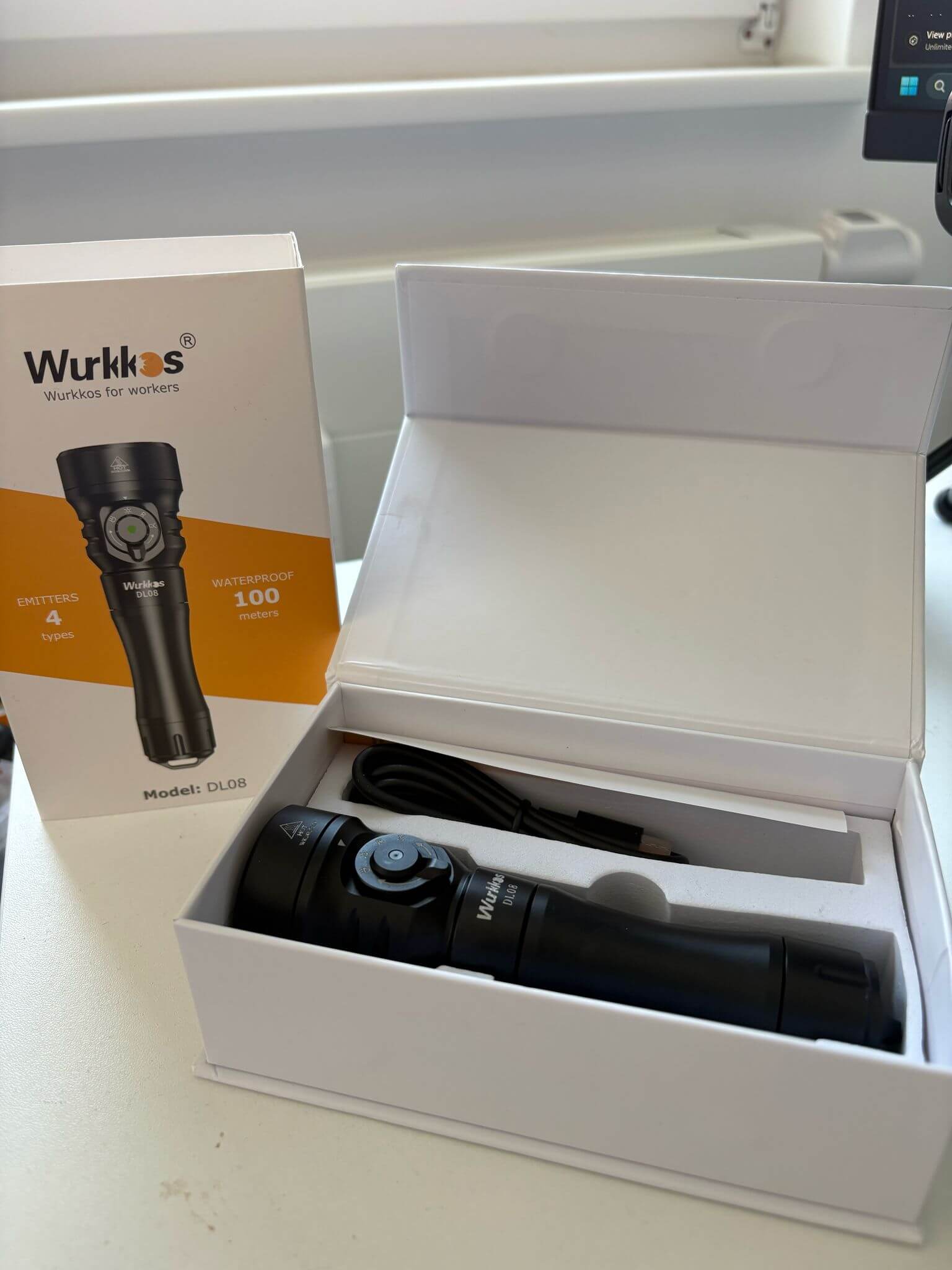 Wurkkos DL08 liegt für den Test Review auf einem Tisch im Karton neben der Verpackung