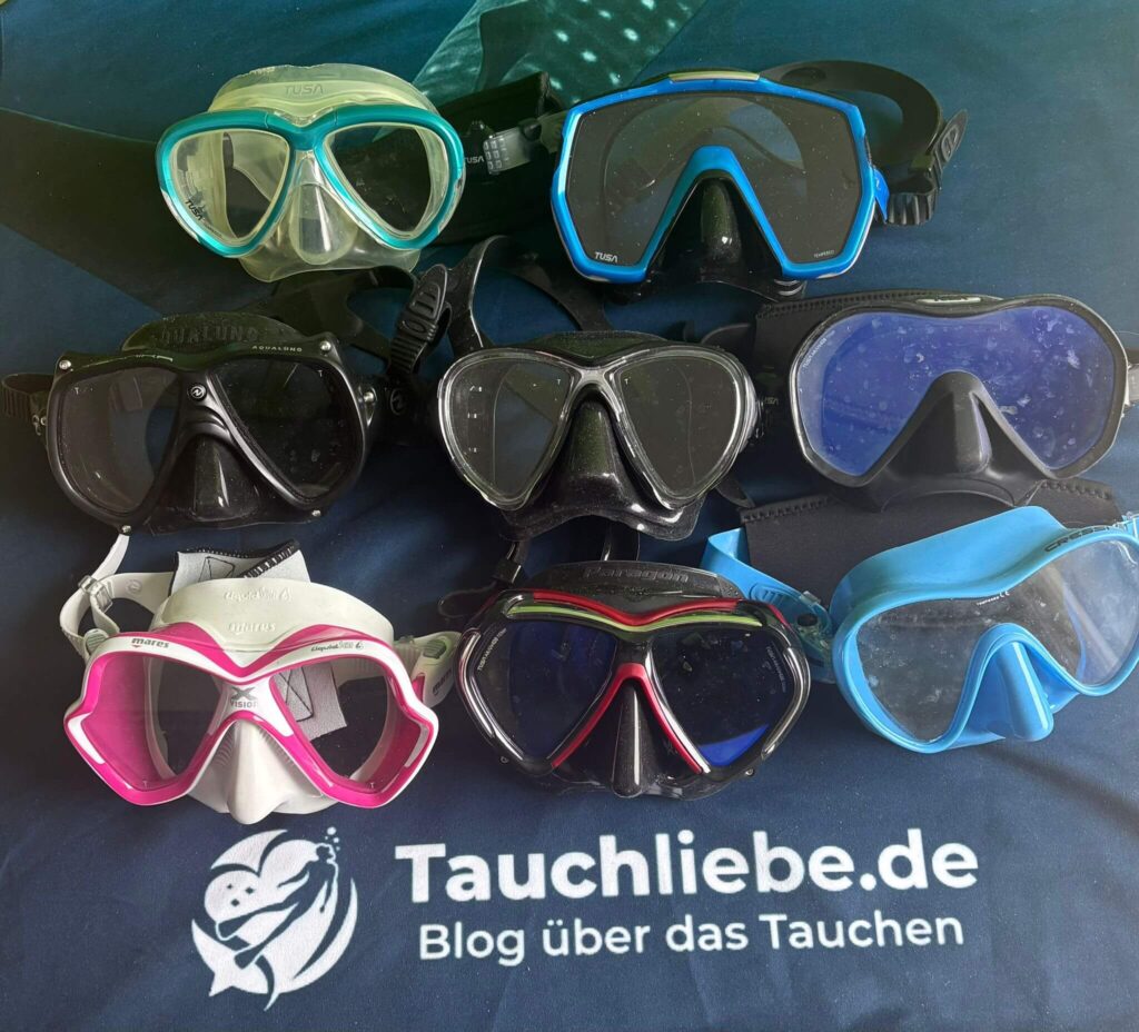 Acht Tauchmasken liegen vor dem Material Test afu dem Tauchliebe.de Handtuch
